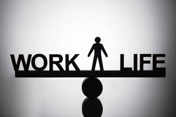 istock Human Figure Standing Between Work And Life Balance 1050882126