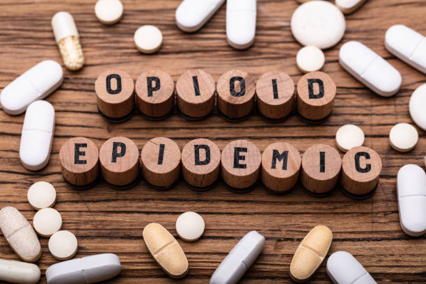 Opioid Epidemic Text On Cork With Prescription Pills Opioid Epidemic Text On Cork With Spilled Prescription Pills Over Wooden Background Opioid Abuse stock pictures, royalty-free photos & images