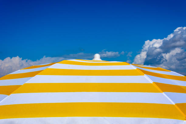 istock Sun umbrella and blue sky 1050887674