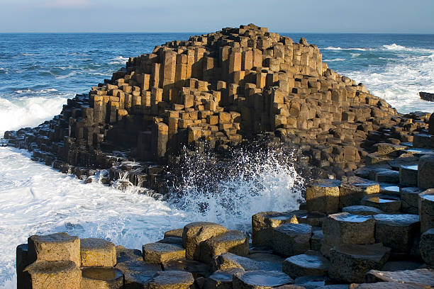 Giants Causeway, Northern Ireland Basalt columns rising from the sea. This geological feature results from erosion on ancient volcanic larva. This unique tourist attraction is the feature of some lovely Irish legends. giants causeway photos stock pictures, royalty-free photos & images