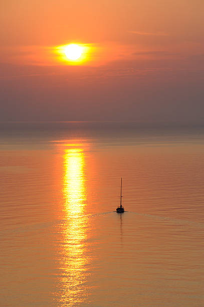 istock Sailboat in the calm at sunrise . 105089629