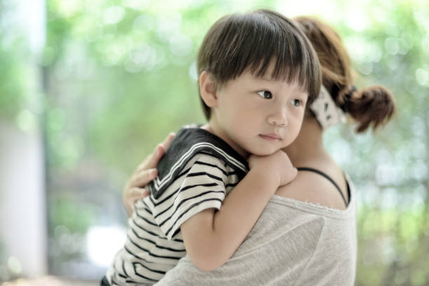istock Little cute asian boy hugging her mother 1050899222