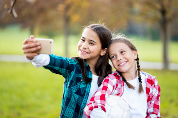 istock Two little girls taking a selfie in nature 1050902496