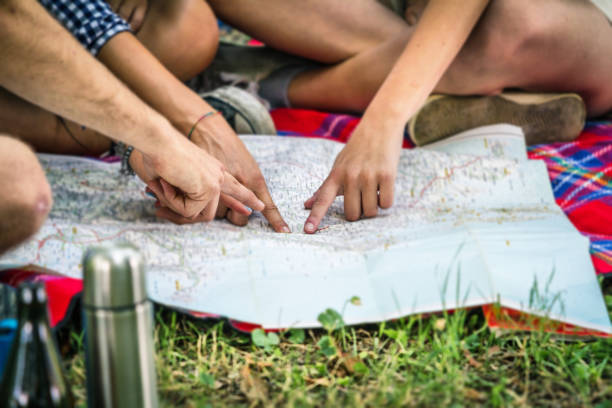 istock Group of friends planning a trip on map at camping 1050902520