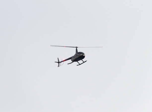 istock Helicopter Flies By in the Sky 1050902742