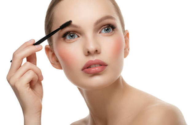 istock Beautiful woman applying mascara 1050905986