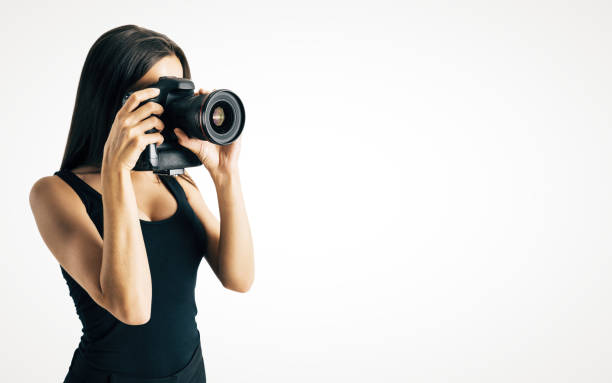 istock Woman taking photo on white background 1050906360