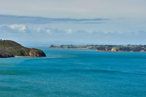 istock View of blue waters across a bay under a bright blue sky with some clouds 1050930794