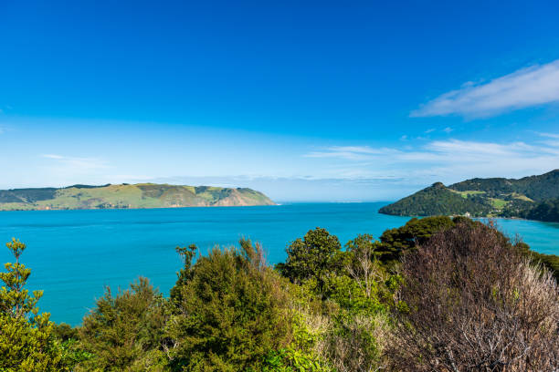istock View of blue waters across a bay under a bright blue sky with some clouds 1050930862
