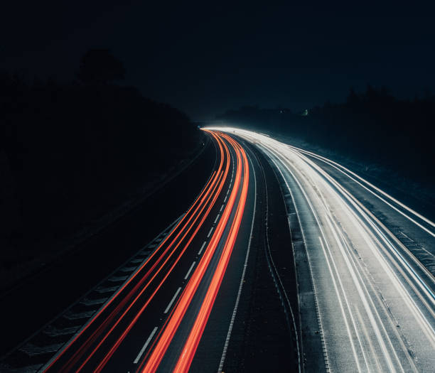 istock Headlights and Taillights on Motorway at Night in UK 1050933110
