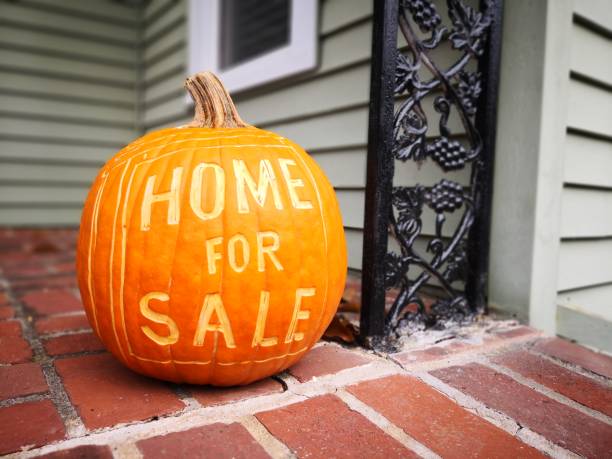 Home For Sale Sign - Fall Open House showing during fall time using a pumpkin carved with a for sale sign. for sale sign photos stock pictures, royalty-free photos & images