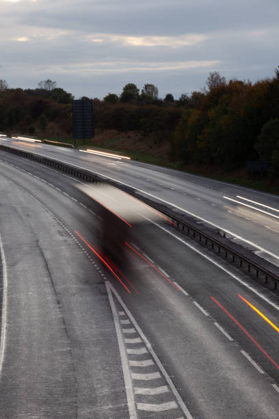 istock Headlights and Taillights on Motorway at Night in UK 1050933692