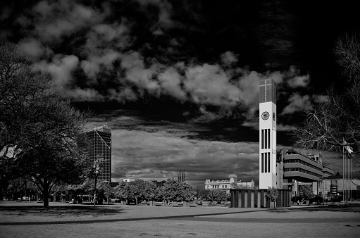 Clock tower in the town square at Palmerston North against a cloudy dark sky