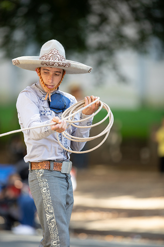 Washington, D.C., USA - September 29, 2018: The Fiesta DC Parade, Mexican man dress up as a charro handling a lasso