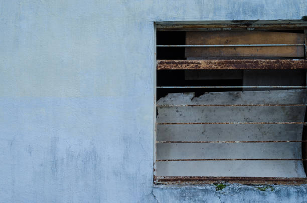 istock Half a window of a blue house. 1050952828