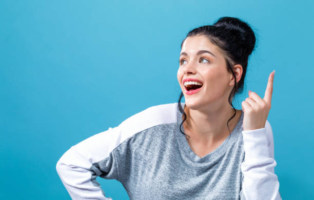 istock Young woman reaching and looking upwards 1050955542