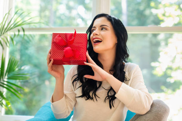 istock Young woman with a gift box 1050955606