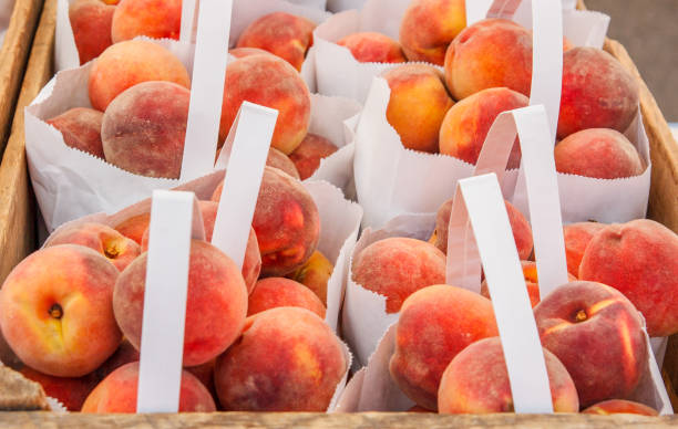 Peaches in Bags and Crates for Sale stock photo