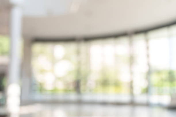 istock Blur background interior view looking out toward to empty office lobby and entrance doors and glass curtain wall 1050964218