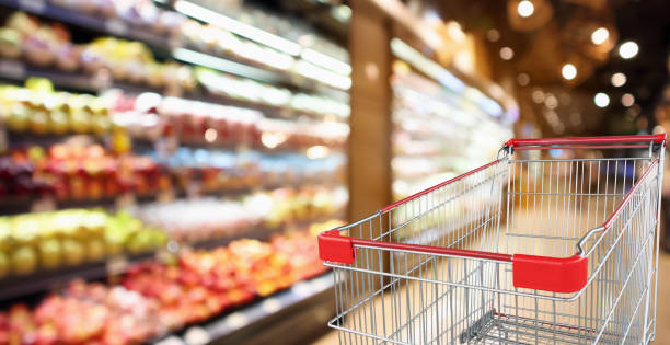 istock supermarket grocery store with fruit and vegetable shelves interior defocused background with empty red shopping cart 1050964320