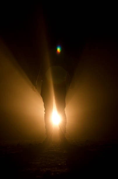 istock mysterious silhouette of unknown man standing in darkness 1050967496
