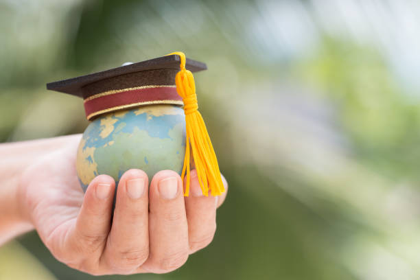 istock Education world or Graduated study abroad international ideas. Graduation hat on top Earth globe model map background. Congratulations to graduates university lead to success in world. Back to School 1050972906