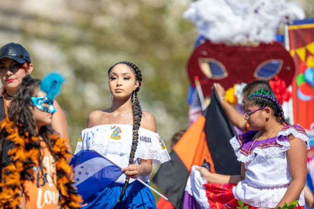 Fiesta DC Parade Washington, D.C., USA - September 29, 2018: The Fiesta DC Parade, Woman from Honduras waving the national flag and wearing traditional clothing hondurian flag stock pictures, royalty-free photos & images