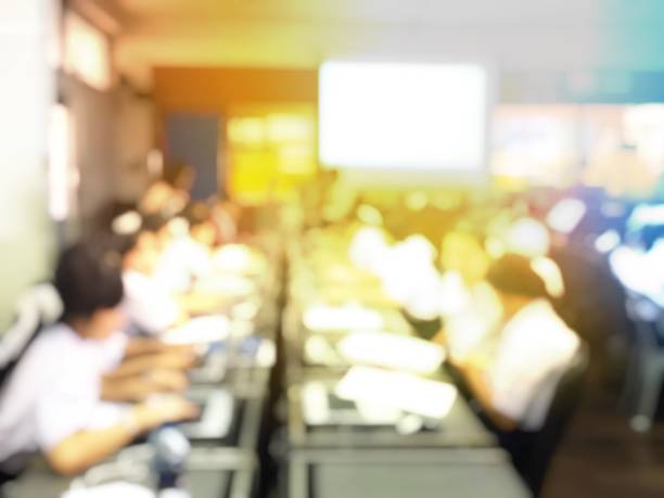 istock Blurred image of group of students are learning and lecture and using computer together in classroom for study and workshop in computers room at school. education technology or training concept. 1050999940