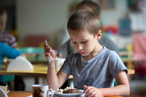 Boy child does not want to eat. Bad appetite. Eating in kindergarten