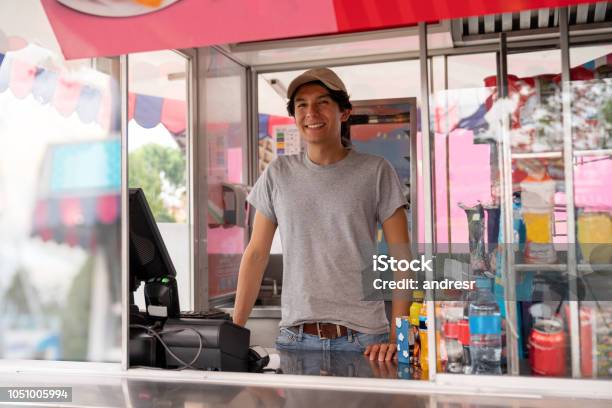 Man Selling Food In A Truck At An Amusement Park Stock Photo - Download Image Now - Traveling Carnival, Amusement Park, Food