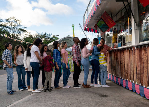 happy people buying food at an amusement park - in line imagens e fotografias de stock