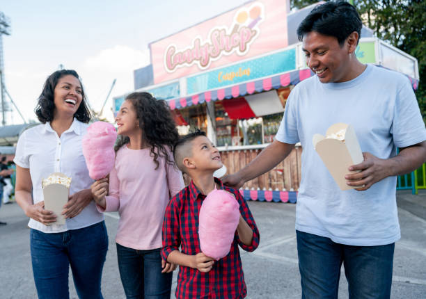 istock Happy family having fun at an amusement park 1051006092