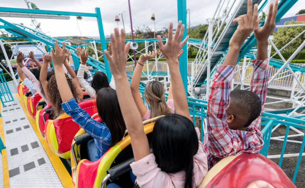 Williamsburg, VA, USA August 3 People start to yell as their extreme roller coaster heads into a descent at an amusement park in Williamsburg, Virginia