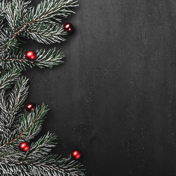 istock Upper, top, view from above, evergreen branches, tree globes  on black square background, with space for text writing, greeting. 1051009452