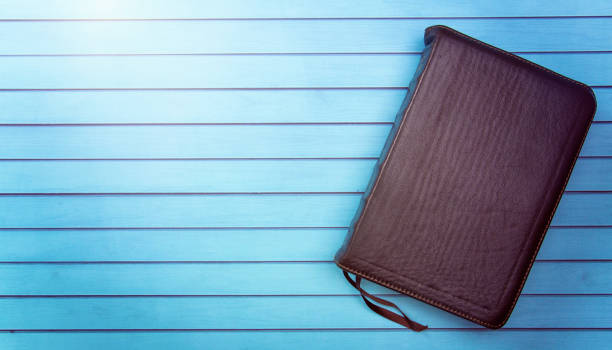 A Bible on a Wooden Table Set out for a Personal Bible Study A Bible on a Wooden Table Set out for a Personal Bible Study verses stock pictures, royalty-free photos & images