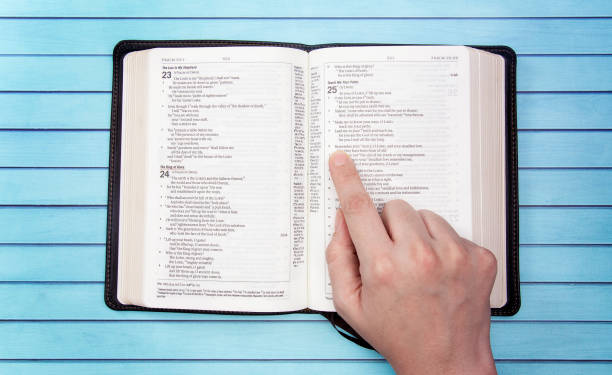 A Bible on a Wooden Table Set out for a Personal Bible Study A Bible on a Wooden Table Set out for a Personal Bible Study verses stock pictures, royalty-free photos & images