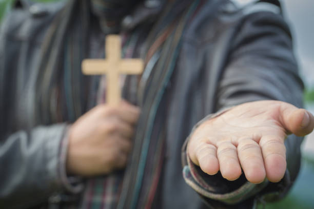 Human hand holds cross and open palm up worship. Eucharist Therapy Bless God Helping Repent Catholic Easter Lent Mind Pray. Christian concept background.