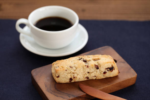 istock dried fruit scone biscuit with a cup of coffee on wood table 1051014530
