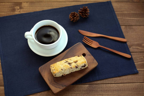 istock dried fruit scone biscuit with a cup of coffee on wood table 1051014702