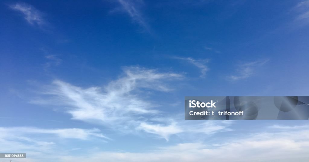 Beauty cloud against a blue sky background. Clouds sky. Blue sky with cloudy weather, nature cloud. White clouds, blue sky and sun. Beauty cloud against a blue sky background. Clouds sky. Blue sky with cloudy weather, nature cloud. White clouds, blue sky and sun Blue Stock Photo