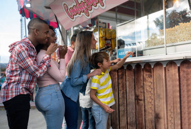 istock Happy people buying popcorn at an amusement park 1051015266