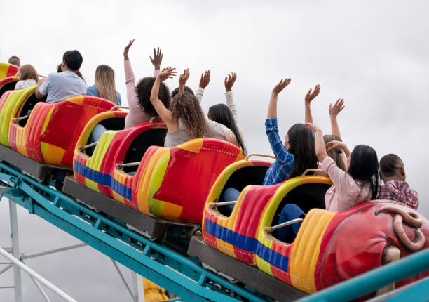 istock Group of people riding on a rollercoaster at an amusement park 1051015360