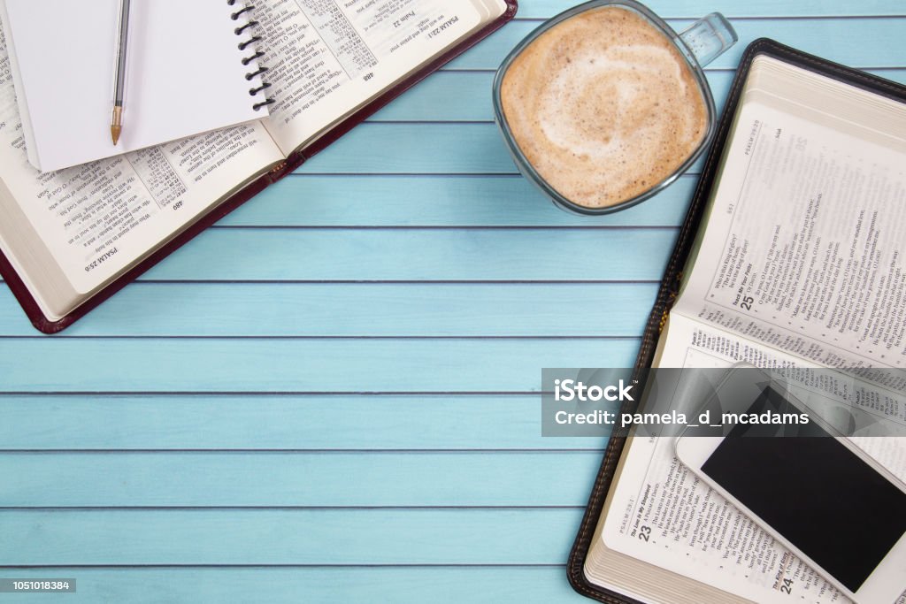 Two People Studying Together Using their Smart Phones as a Resource Bible Stock Photo