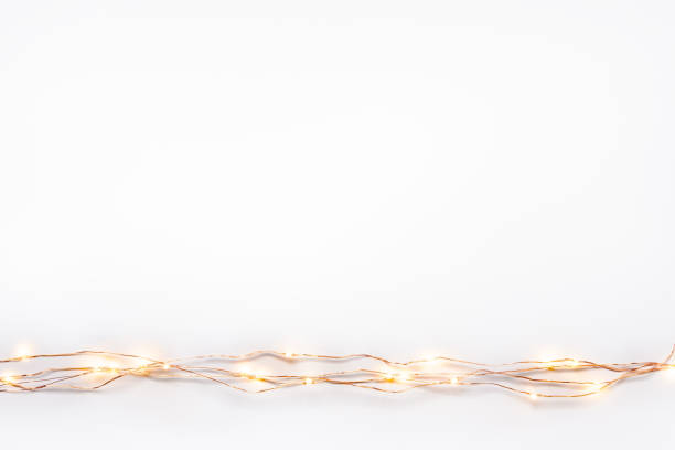 istock Christmas lights garland border over white background. Flat lay, copy space. 1051024070