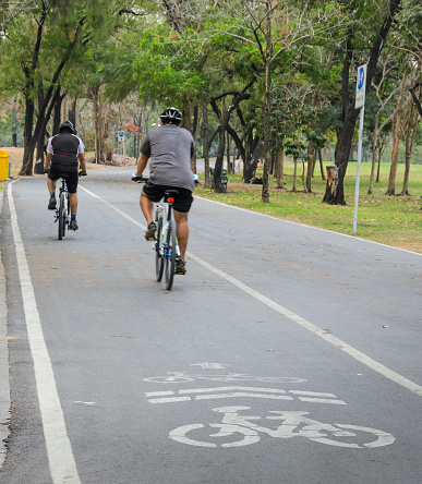 Bangkok, Thailand - February 5, 2014 : Unidentified men riding bicycle in the morning at public park