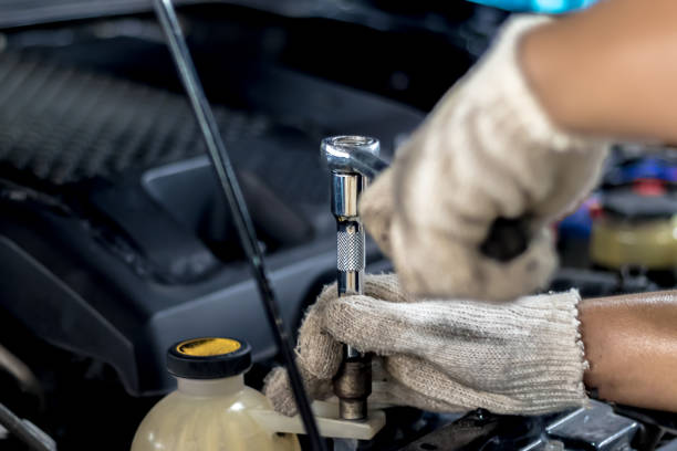 istock People are repairing a car Use a wrench and a screwdriver to work. 1051027106