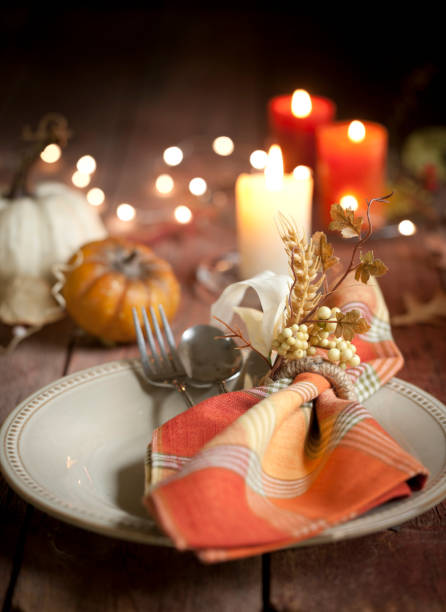 istock Autumn Thanksgiving holiday dining table place setting on an old wood rustic table 1051038226
