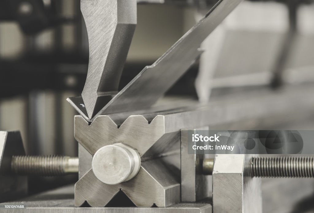 bending metal on a sheet bending machine, at the factory Bending Stock Photo