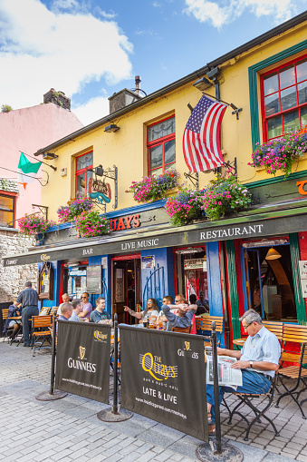 Galway, Ireland - August 18, 2012: Men relaxing on a summer's day at The Quays bar in Shop Street in Galway,  Ireland.