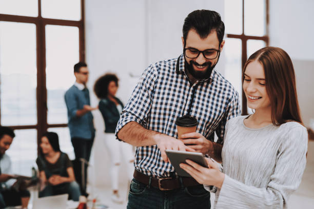 istock Work Together. Office. Guy and Girl. Talking. 1051052350